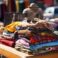 a pile of vintage clothing on a table at a flea market, created with generative ai